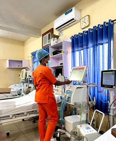 A healthcare professional attending to hospital equipment at Leeds Hospital